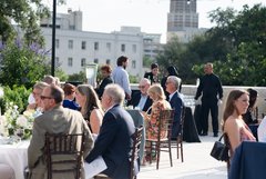 Guests seated at tables on an outdoor rooftop terrace