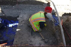 Archaeologist excavating inside a unit