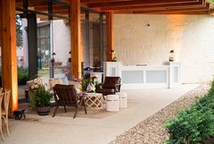 White bar set up next to wall and lounge seating in front in arbor of Ralston Family Collections Center