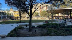 Outdoor park area with a pavilion stage and the ground being prepped for new plants