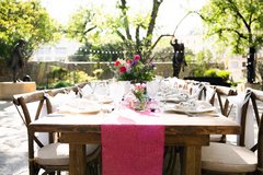 Farmhouse table with pink runner and floral centerpiece in Cavalry Courtyard