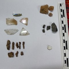 Artifacts from excavation - metal objects and nails, European earthenware, clear and olive container glass, and construction materials, such as brick