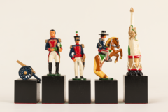 Five chess pieces on black squares - a cannon, two soldiers, a man on horseback, and a flag on a drum