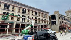 Green construction crane outside of historic Crockett building