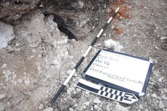 Black and white pole and whiteboard in excavation area
