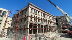 Crockett Building under construction with a large crane overhead