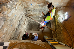 Archaeologists Working Deep Within A Excavation Unit Archaeologists Working Deep Within A Excavation Unit