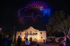Bull in drone lights over Alamo Church at night