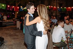 Couple dancing with string lights in the background