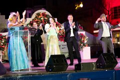 Men and women on stage celebrating with applause at an event