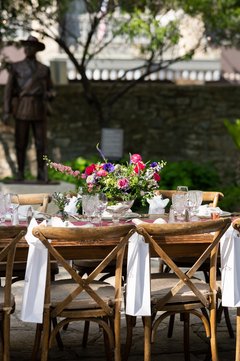 Floral centerpiece on a set table in Cavalry Courtyard