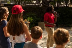 Visitors listen to an Alamo History Talk in Cavalry Courtyard