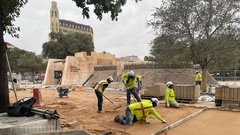 Construction workers with bright yellow vests working outside the Alamo Mission Gate and Lunette