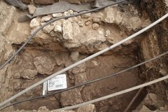 Three tubes across the top of an excavation unit with limestone feature