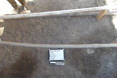 Bottom surface of an excavation unit with two pipes above it