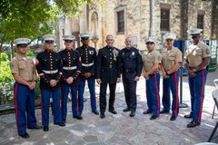 Marine General and fellow Marines smiling and standing in a row