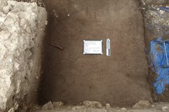 Flat dirt surface inside an excavation unit