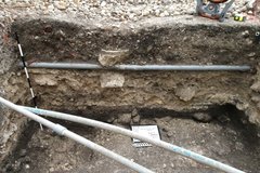 Close up of side of interior excavation unit with piping across it