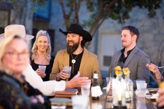 Guests laughing over cocktails at an event