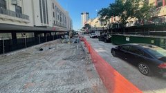 Construction area with orange netting as divider to allow some traffic for vehicles