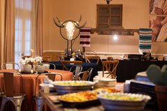 Buffet of food and tables set up for an indoor event