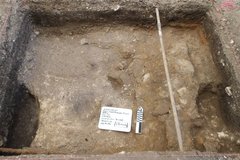 Stone and sandy mortar alignment at the bottom of an excavation unit