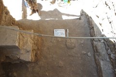 Inside an excavation unit from a shaded angle showing a shadow
