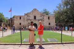 Harini Logan and Kate Rogers in Alamo Plaza, holding plague