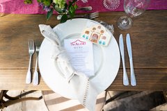 Table setting with a menu and Alamo shaped cookie