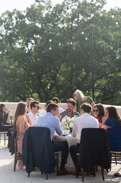 Guests seated at round tables at an outdoor event