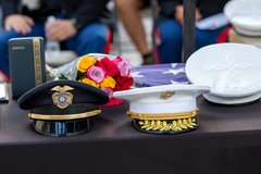 Marine General cap, Officer cap, flowers, and a folded flag on a table
