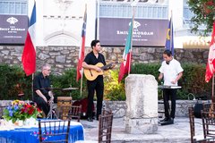 Trio of musicians playing guitar, drums, and percussion