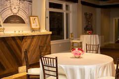 Table set with colorful flowers and a white linen inside penthouse