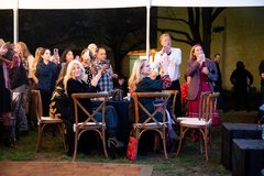 Guests seated at a table listing to remarks at an event