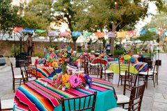 Close up of round table with colorful runner and centerpiece
