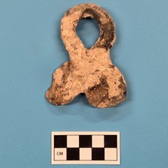 Ribbon shaped artifact with copper color