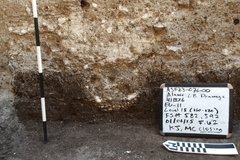 Posthole with a white board and ruler for size