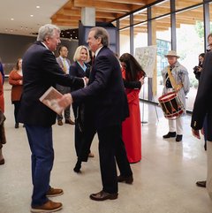 Two men shaking hands greeting each other in a lobby