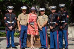 Wife of Marine General standing with Marines after a ceremony
