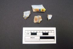 Four small ceramic fragments with multi color designs