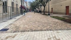 Paved area of Crockett Street with fencing on one side