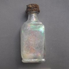 Glass bottle with a metal copy from an excavation