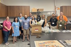 A group of people smiling in a laboratory