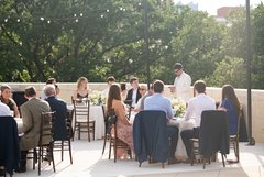Guests seated at tables on an outdoor terrace