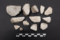 Mortar and plaster recovered from an excavation unit next to a ruler for size