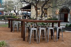 Wood tables set outside of Alamo Hall for an outdoor event
