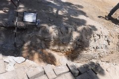 Inside of backhoe trench with some bricks at the side