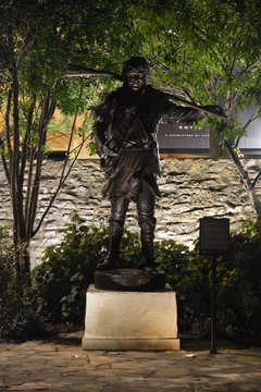 Statue of David Crockett in Cavalry Courtyard lit up at night