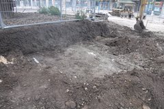 Grading along the base of planter walls in construction area