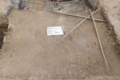 Top level of excavation unit with two crossed pipes